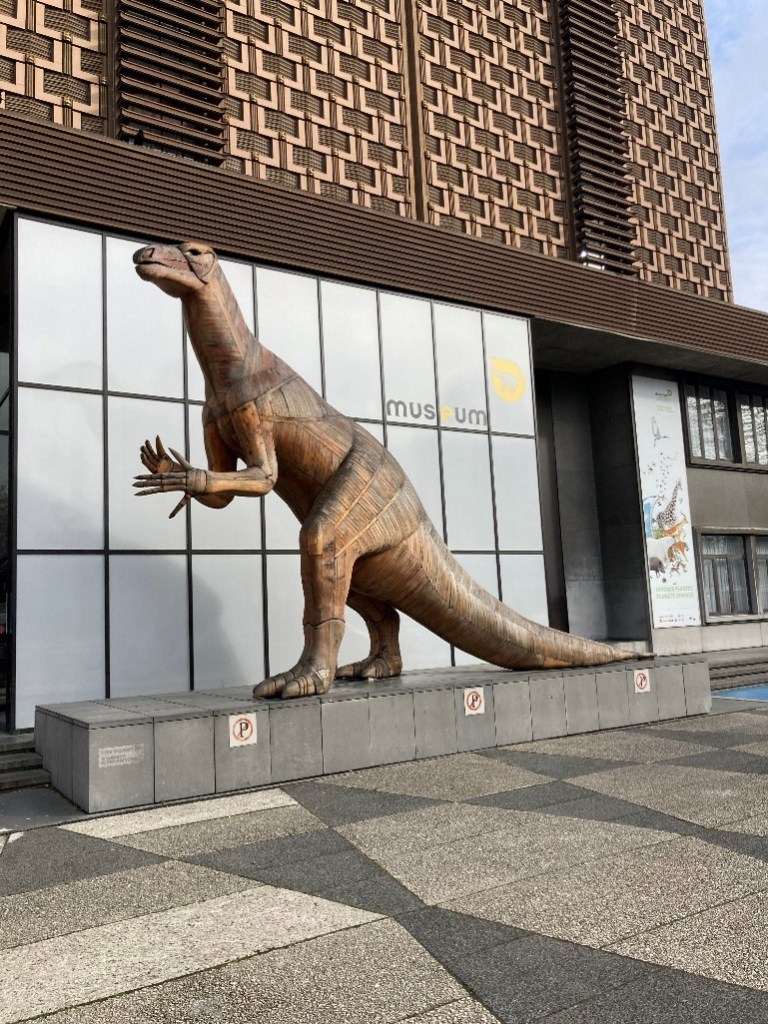 Picture of a sculpture of a dinosaur outside the museum building